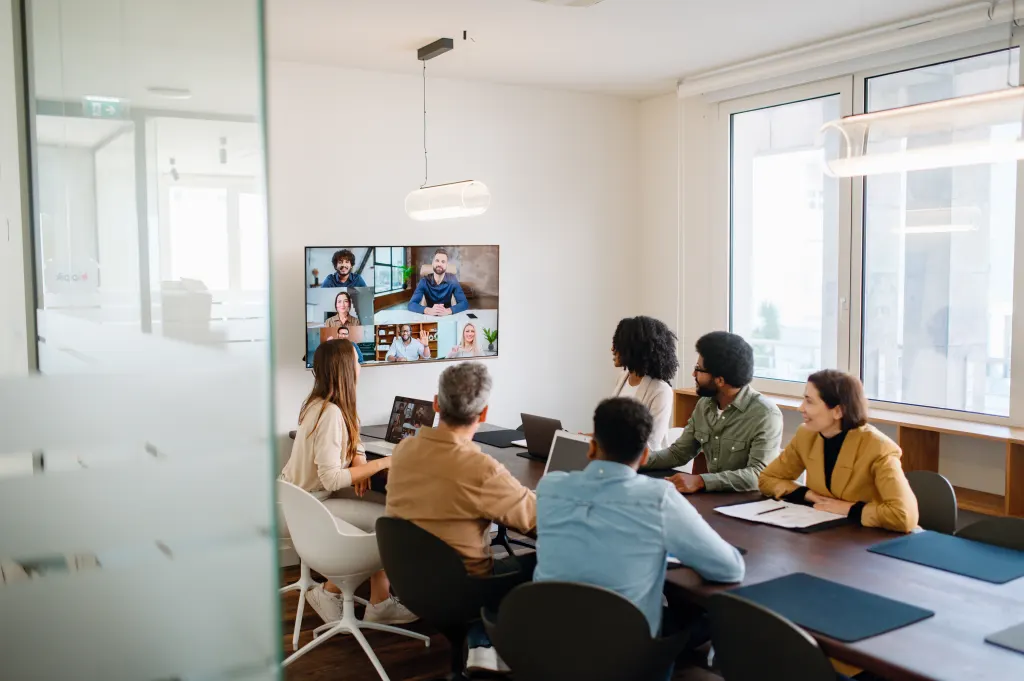 Illustration: A diverse team of professionals enthusiastically participates in a video conference call