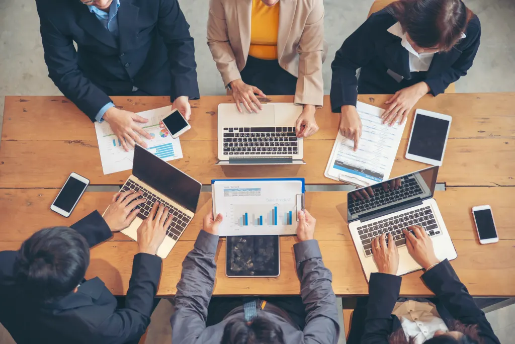 Illustration: Group of People working together with laptop on wooden office de